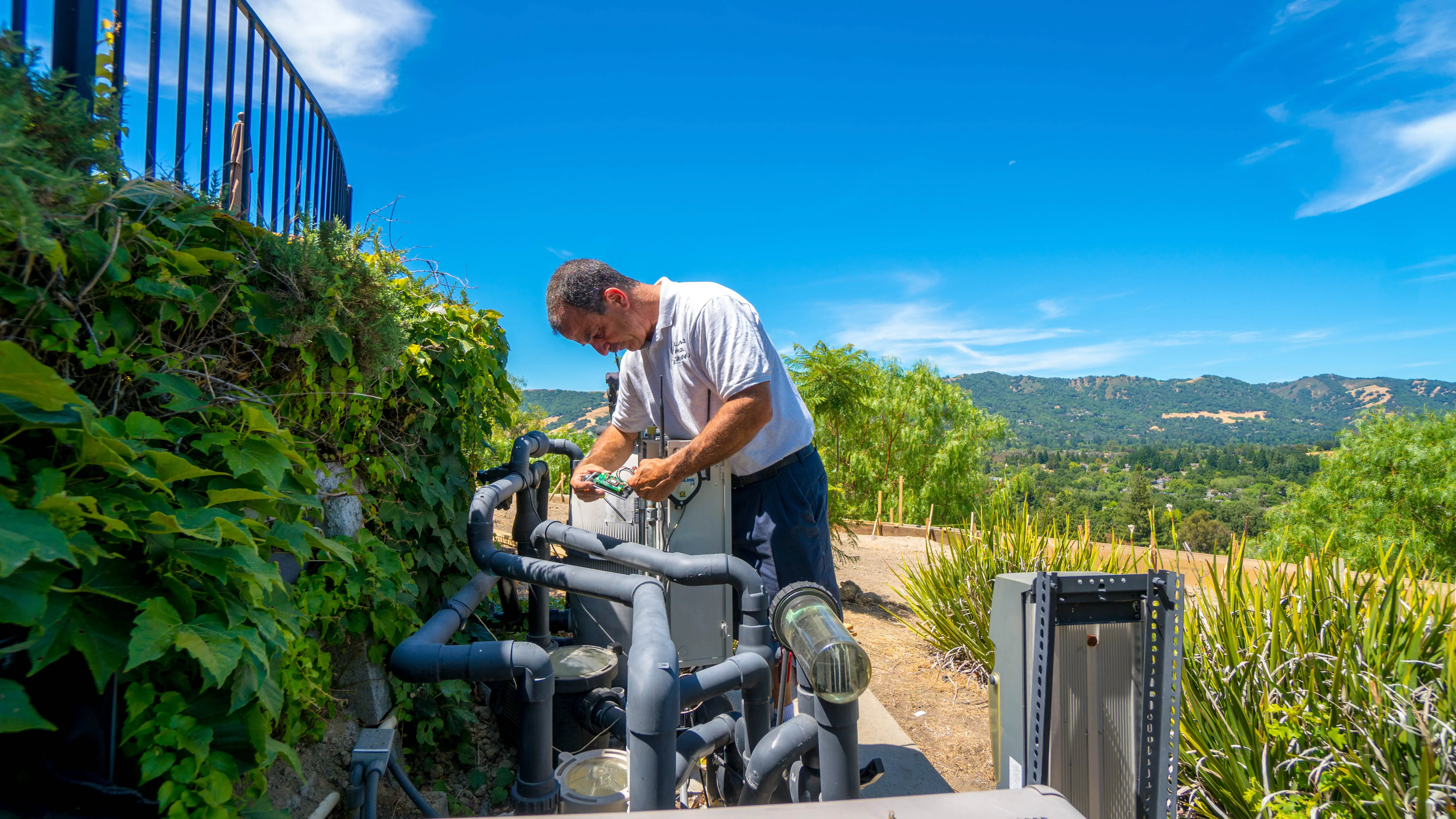 Pool equipment repair - Atlantis Pools technician servicing pool equipment